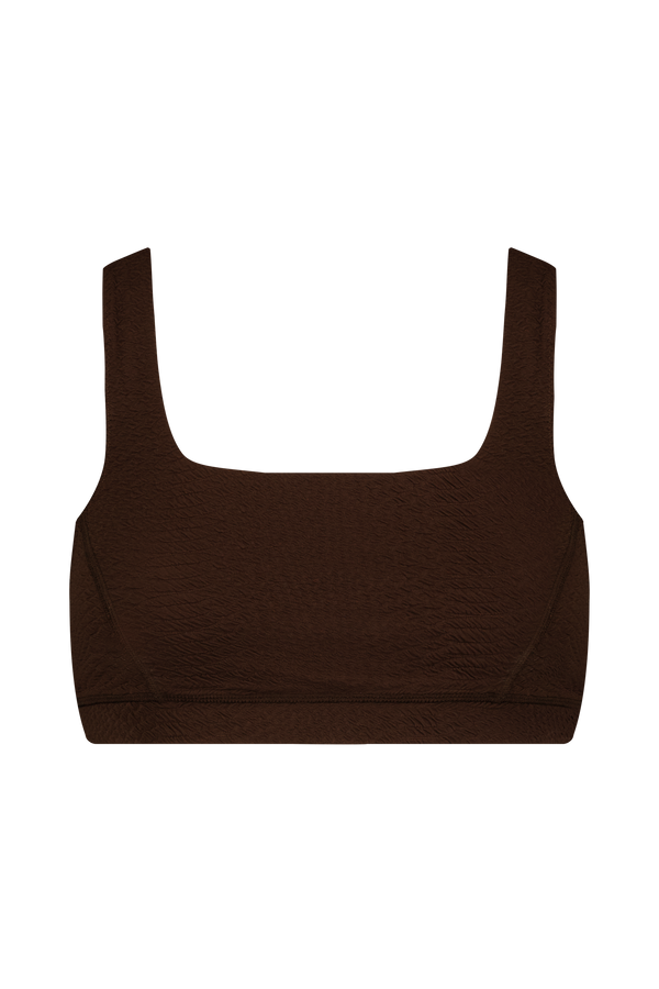 The Wilson Bra by Gigi C Sport is a brown, textured sports bra with wide straps and a shelf bra, featuring a square neckline against a plain black background.