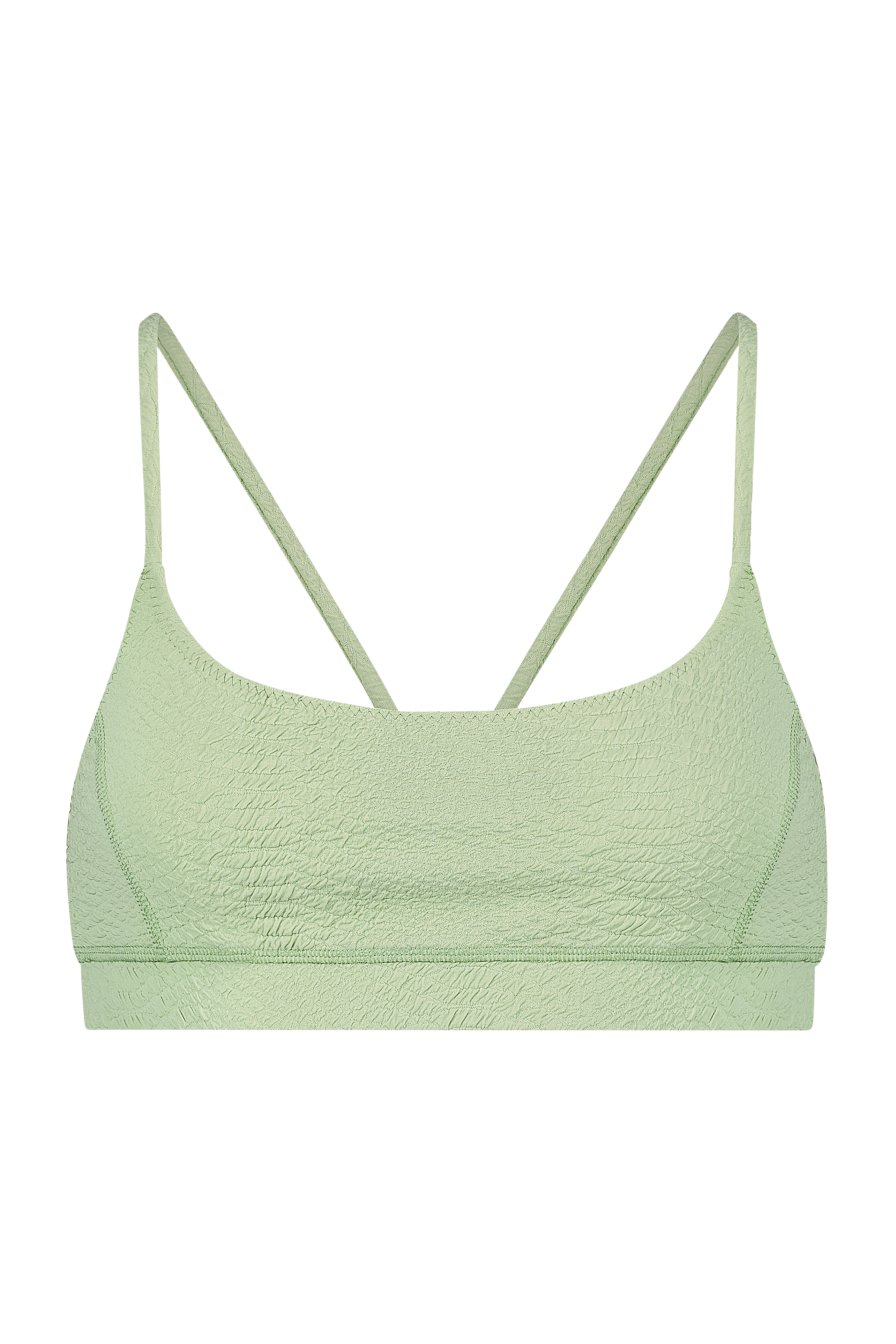 The Gigi C Sport Emery Bra is a light green, textured bralette with spaghetti straps, providing light support. Made from breathable knit fabric, it features a crinkled look and a simple design set against a solid black background.