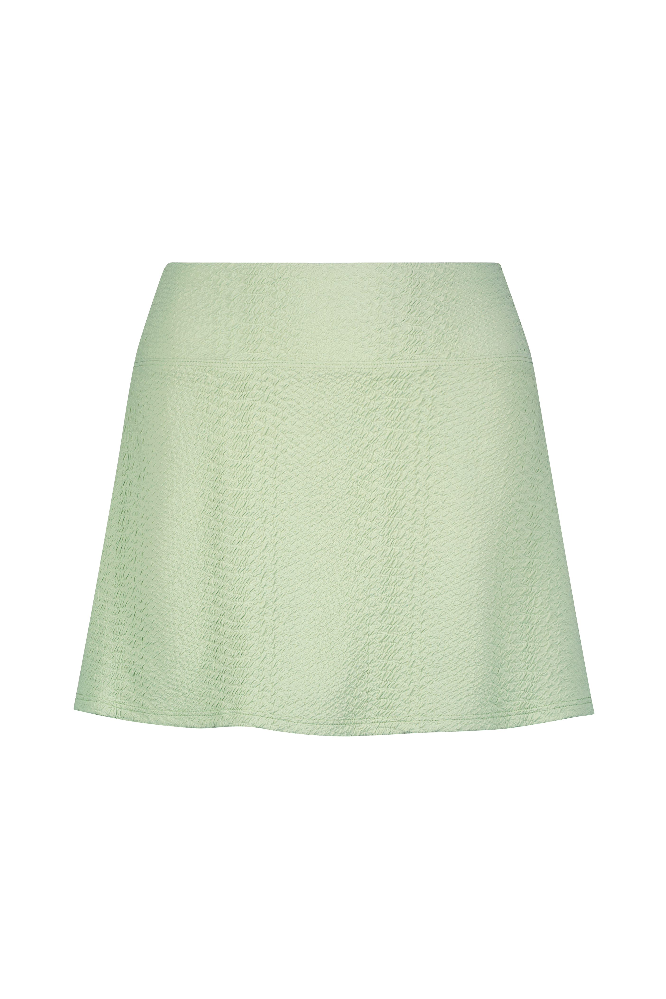 The Heidi Skirt by Gigi C Sport is a mini design featuring light green texture on a black backdrop. Made from bi-stretch compression waffle jacquard fabric, it offers an A-line shape, fitted waist, and subtle vertical seams.