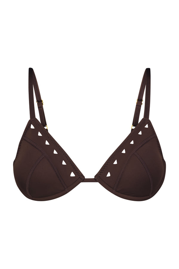 The Alice Bra by Gigi C Bikinis in the Resort 2025 Collection is a brown bikini top with triangle cups and adjustable straps, made of sleek scuba fabric featuring decorative cut-out triangles along the edges.